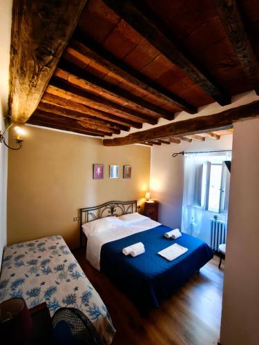 a bedroom with a bed with two towels on it at Alla Meria in Castiglione della Pescaia