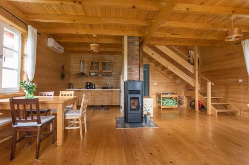 a kitchen and dining room with a stove in a cabin at Holiday Homes Vita Natura in Rakovica