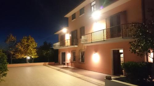 an empty parking lot in front of a building at night at B&B Verde Irpinia in Gesualdo
