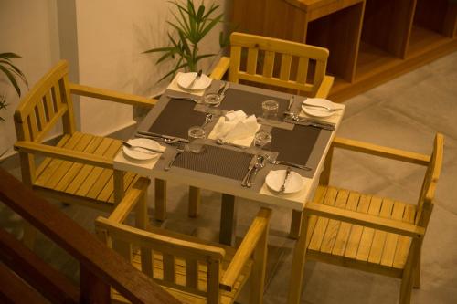 an overhead view of a dining table and chairs at Kuredhi Beach Inn in Maafushi