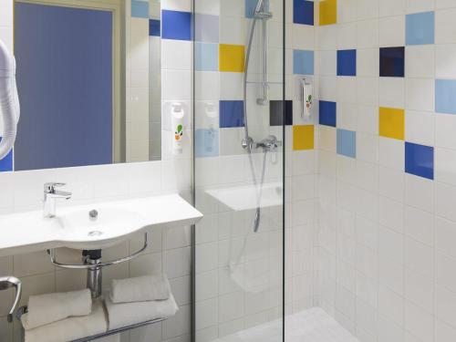 a bathroom with a sink and a shower at Ibis Styles Collioure Port Vendres in Port-Vendres