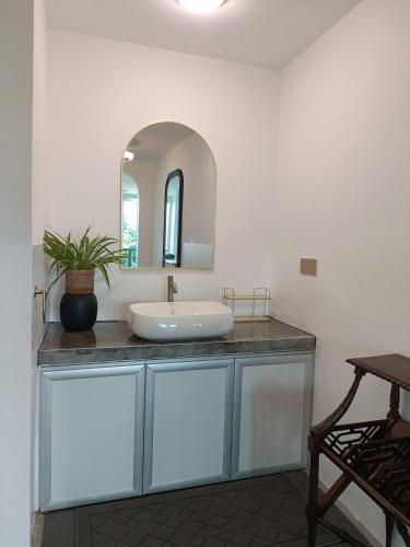 a bathroom with a sink and a mirror at Spacious & Scenic View with Swimming Pool Aza Sunset Villa 2 in Langkawi Intl