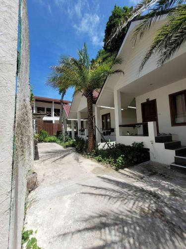 a house with palm trees in front of it at Diamond Beach Resort in Ko Samed