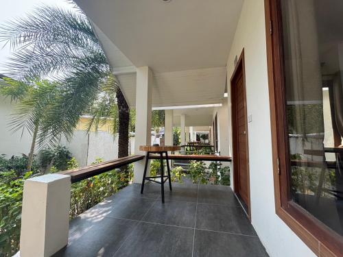 a balcony with a table and a palm tree at Diamond Beach Resort in Ko Samed