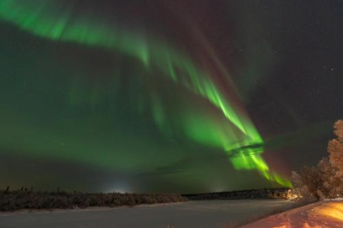 an image of the northern lights in the sky at Riverhouse studio in Ivalo