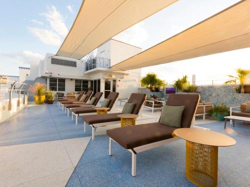 a row of chairs and tables on a rooftop patio at Clevelander Hotel in Miami Beach