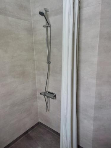 a shower in a bathroom with a shower curtain at Astrid40 in Bruzaholm