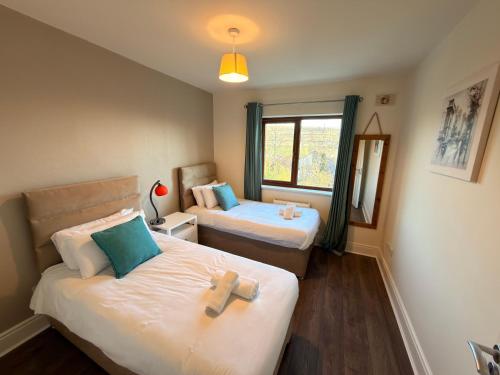 a room with two beds with crosses on them at Cois Cairn in Dingle