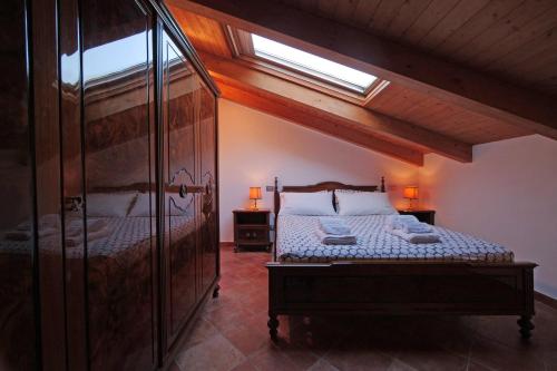 a bedroom with a large bed and a window at Casa Marcone in Deiva Marina