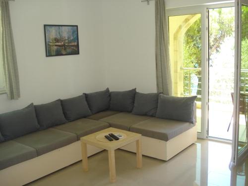 a living room with a couch and a coffee table at Apartments Villa Danilovic in Herceg-Novi
