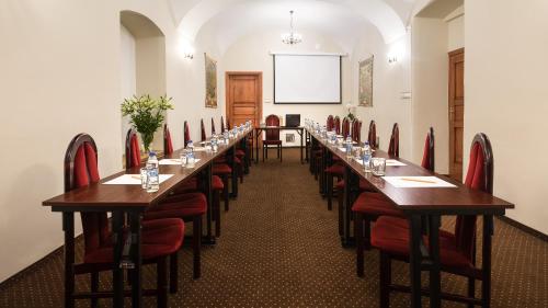 a large room with a long row of tables and chairs at Hotel Wit Stwosz in Krakow