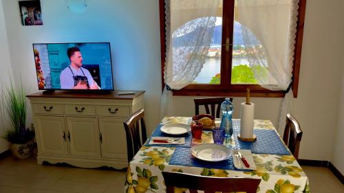 a dining room with a table with a tv on top at VistaBellaBorromeoFlat in Baveno