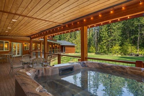 a house with a large pool on a deck at River Road Lodge by NW Comfy Cabins in Leavenworth