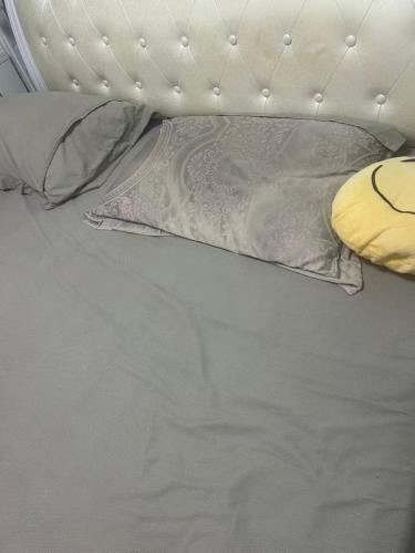 a white bed with a pillow and pillows on it at Bagneux cozy in Châtillon