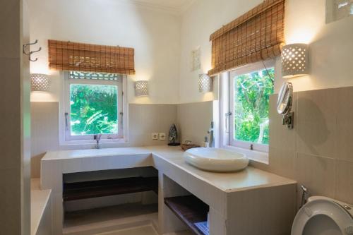a bathroom with a sink and a toilet at Mondo Surf Village in Canggu