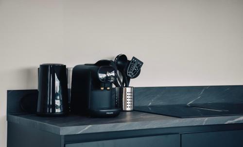 a counter top with a coffee maker and utensils at Villa Nautica | 4 Pers. in Loosdrecht