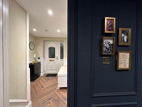 a hallway with a blue door and a bathroom at Riverview House in Minnigaff