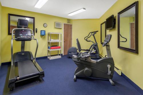 a gym with a treadmill and ellipticals in a room at Howard Johnson by Wyndham Mystic in Mystic