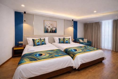 two beds in a bedroom with blue and white at Monaara Leisure - Ella in Ella