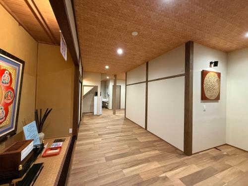 a hallway of an office with wooden floors and white dividers at 宿坊-地蔵院 in Kurayoshi