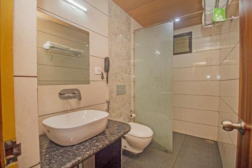 a bathroom with a sink and a toilet at Royal Hotel Gangtok in Gangtok