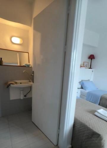 a room with a bathroom with a sink and a bed at Armeos Blue in Myrties