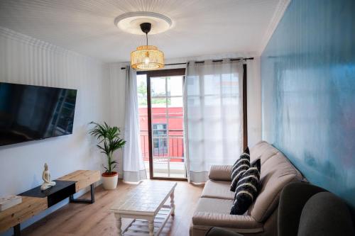 a living room with a couch and a large window at El Hierro Bed in Valverde