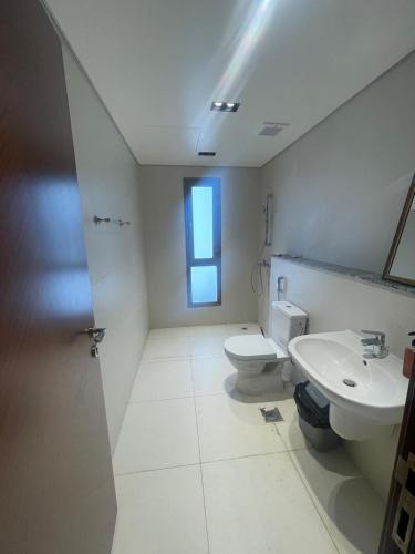 a bathroom with a toilet and a sink at House of Nomads - Hostel in Muscat