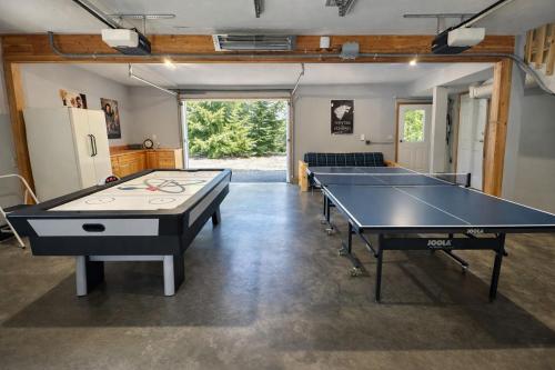 a ping pong room with two ping pong tables at Riverwood Lodge in Leavenworth