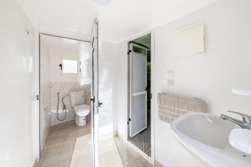 a white bathroom with a sink and a toilet at Private Villa with Pool and Hammam Marrakech in Oulad Akkou