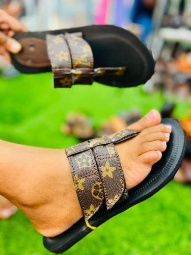 a person wearing shoes with a bow tie on their foot at Mabegi african Designs in Arusha
