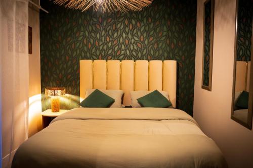a bedroom with a bed and a chandelier at Le 8 Suite Spa Privative Sauna et Jacuzzi parking gratuit in Mâcon