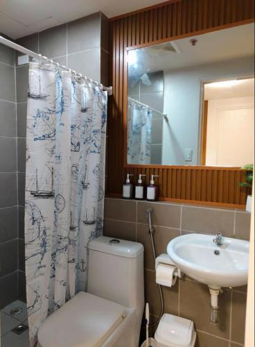 a bathroom with a toilet and a sink at JB Casa del Alivio in Butuan