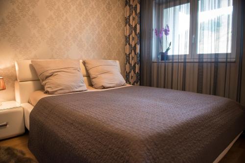 a bedroom with a large bed with a window at Rosaliya in Cochem