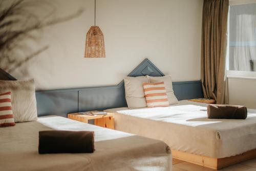 a hotel room with two beds and a window at Villa Maier B&B & Apartments in Soprabolzano