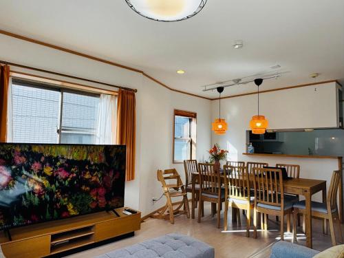 a living room with a dining table and a large aquarium at Kamei House in Tokyo