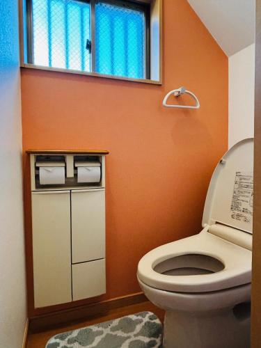 a bathroom with a toilet and a window at Kamei House in Tokyo