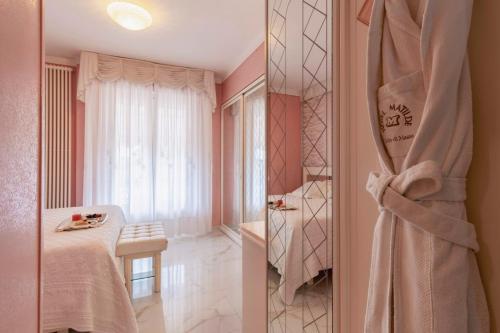 a bathroom with a bed and a shower in a room at Hotel Matilde in Marina di Massa