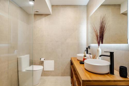 a bathroom with a white sink and a toilet at O Lar de Laura Casa familiar para escapada tranquila con piscina y sala de juegos cerca de Vigo in Vigo