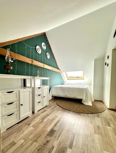 a bedroom with a bed and a green wall at La Pastourelle en Lozère in Le Bacon