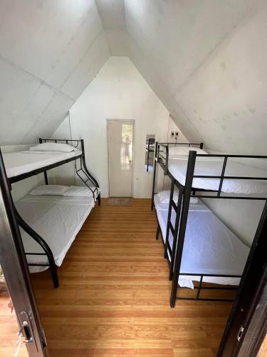 a attic room with three bunk beds in it at Serenity Cove Resort in San Pablo