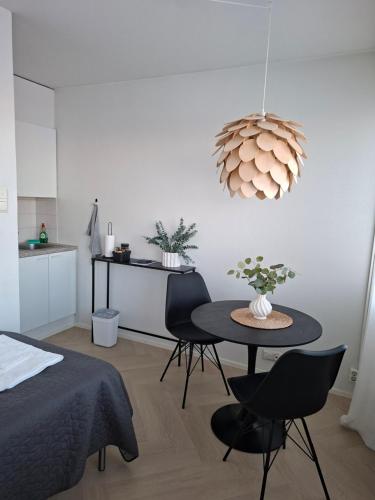 a room with a bed and a table with chairs at Centrum Apartment Kokkola in Kokkola