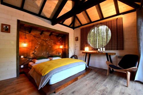 a bedroom with a large bed and a table and chairs at Les 7 Montagnes in Lourdes