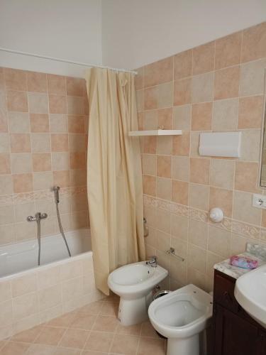 a bathroom with a toilet and a sink and a shower at Fabian Appartament in Bagheria