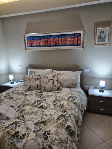 a bedroom with a bed and two night stands with lamps at House Barbanera in Spello
