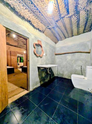 a bathroom with a sink and a mirror at Thanamal-villa in Tanamalwila