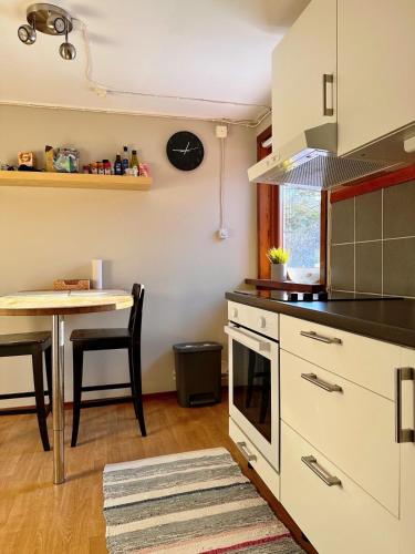 eine Küche mit einem Tisch und einem Herd Oberer Backofen in der Unterkunft Bart’s loft in Älmhult