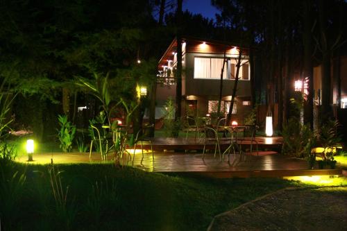 a house with a deck at night with lights at Kaia Apart y Spa in Mar de las Pampas