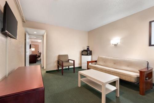 a living room with a couch and a table at Days Inn by Wyndham Lethbridge in Lethbridge
