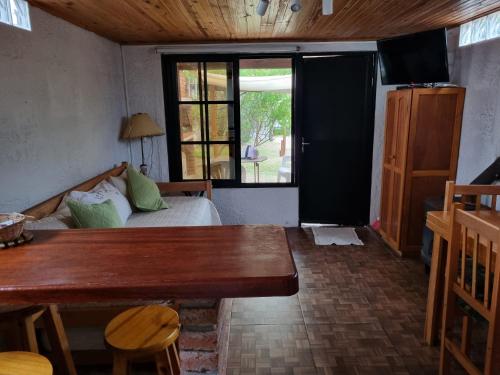 a room with a bed and a table and a window at Los Nietos in La Paloma